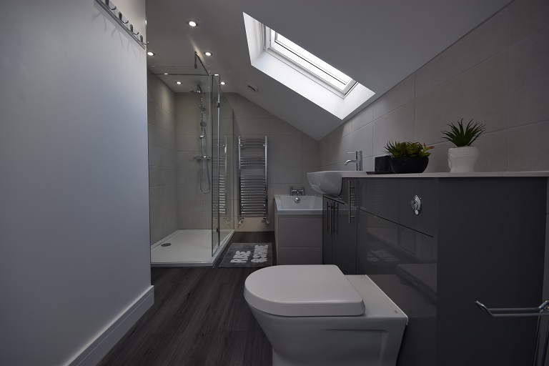 A dark poorly lit loft bathroom