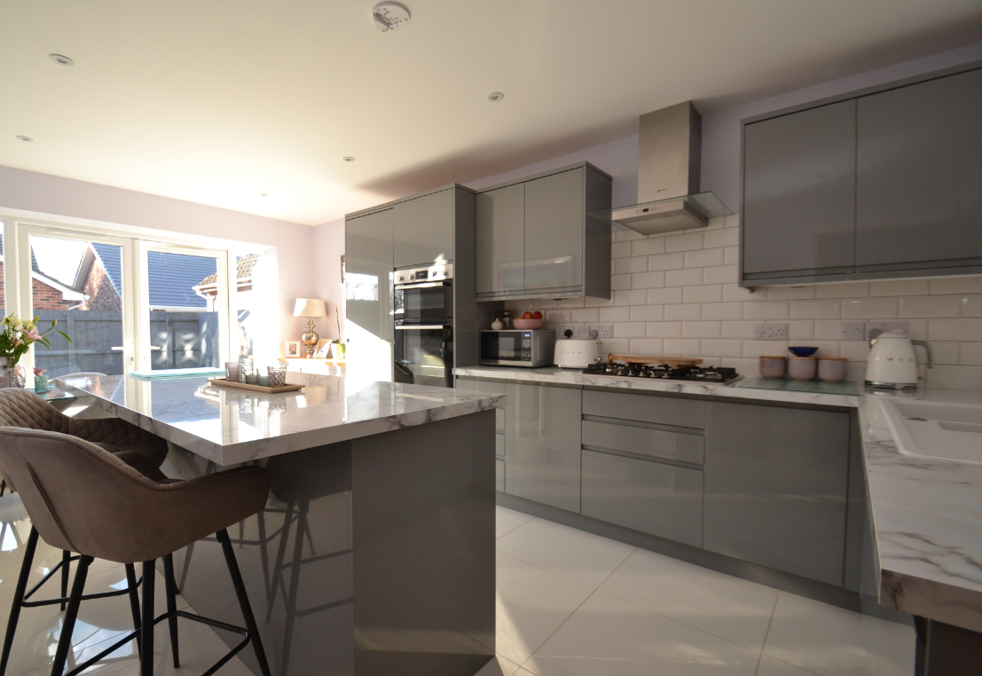 A poorly lit kitchen with bright washed section
