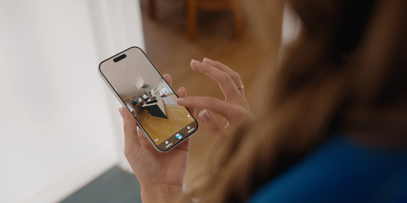 A woman uploading property images to the Made Snappy platform from a mobile phone