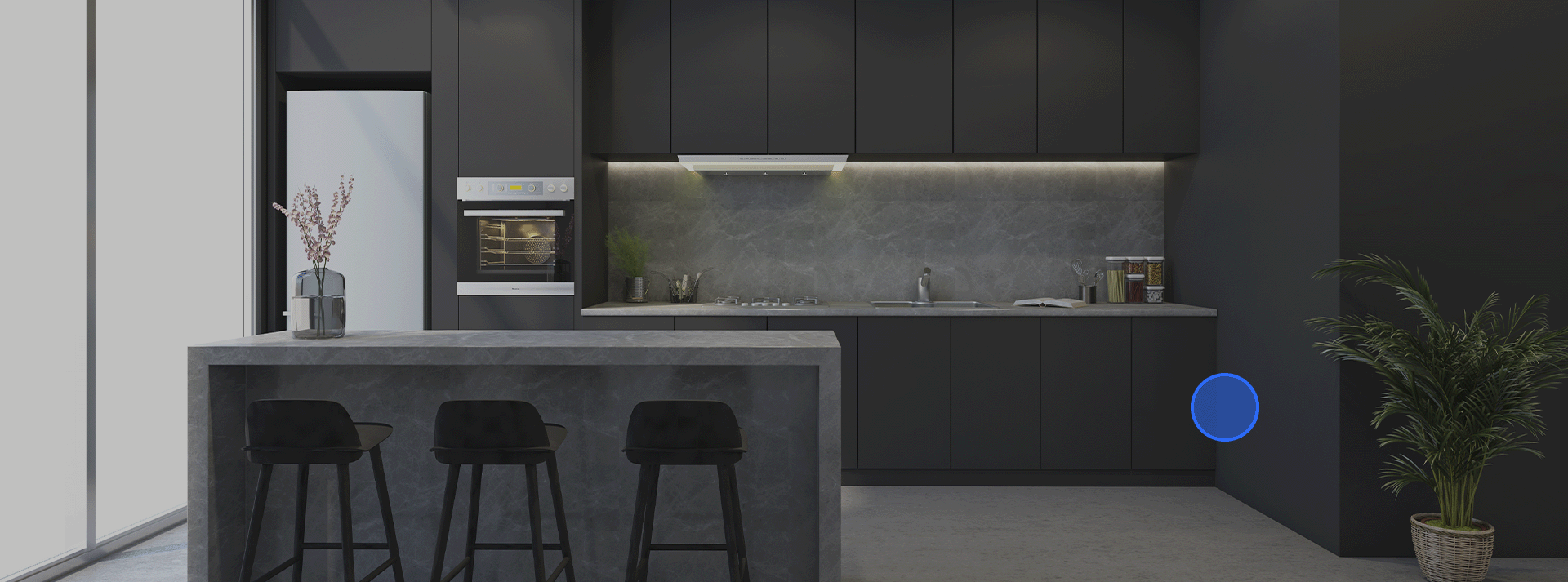 A modern open kitchen with a three seater bar stool island in the foreground with a stunning modern kitchen wall of cupboards and units with hidden led lighting, all in subtle shades of grey